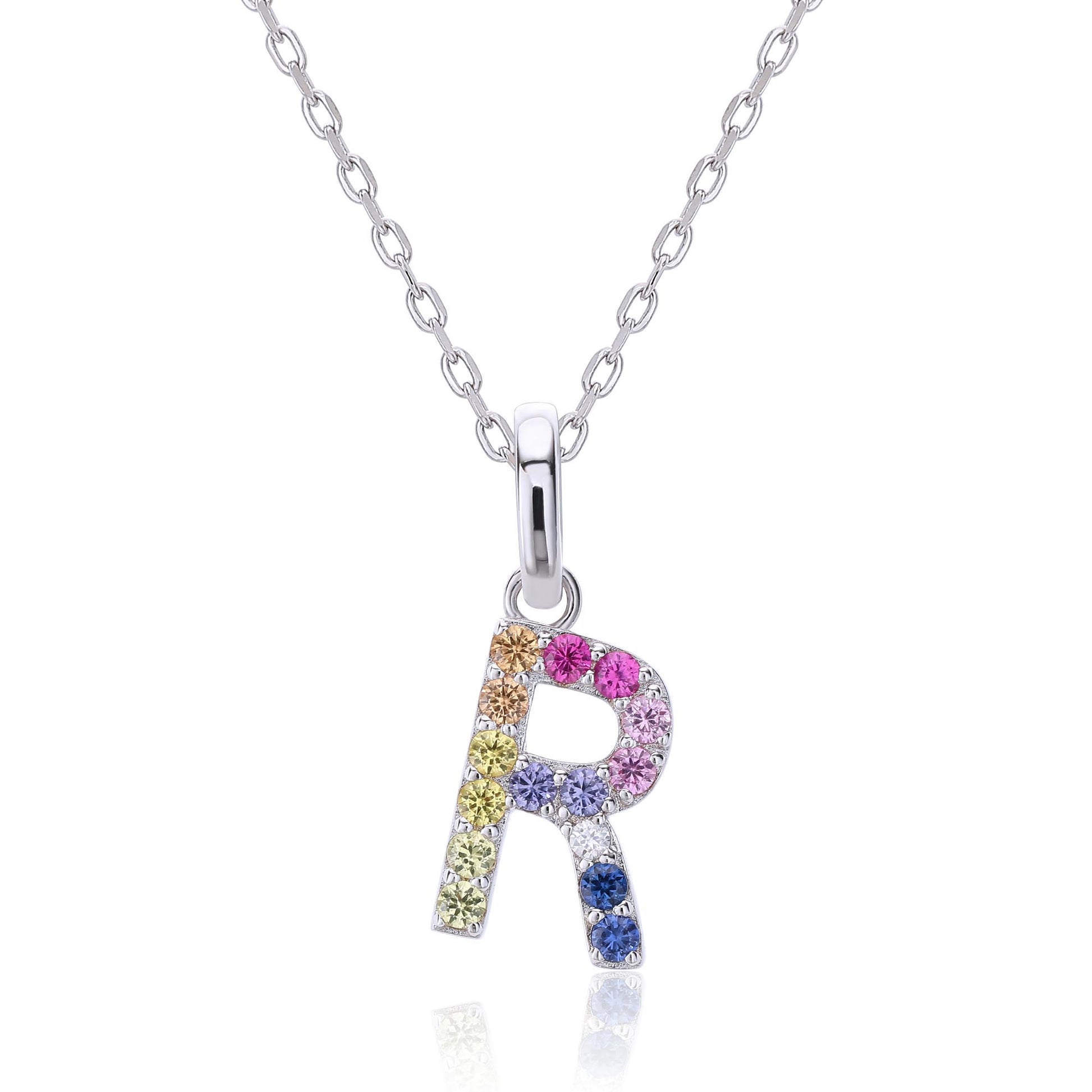 A delicate sterling silver initial necklace holding an uppercase letter R pendant meticulously set with a multi-color rainbow spectrum of round lab sapphires.
