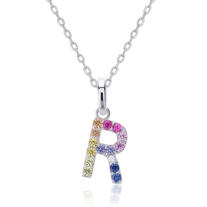 A delicate sterling silver initial necklace holding an uppercase letter R pendant meticulously set with a multi-color rainbow spectrum of round lab sapphires.