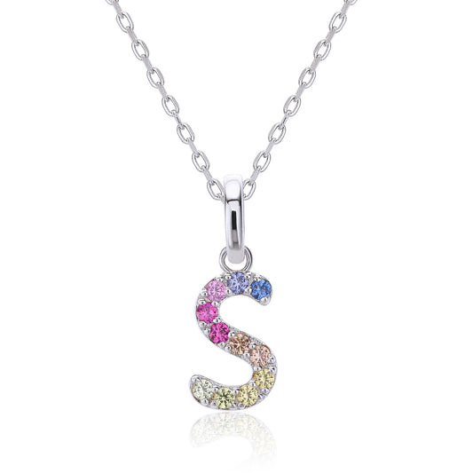 A delicate sterling silver initial necklace showcasing a fluid, serpentine letter S pendant precision-set with a continuous rainbow wave of vibrant round lab sapphires.