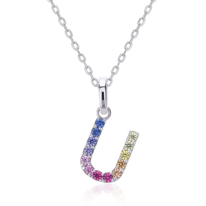 A delicate sterling silver chain necklace suspending an uppercase letter U charm, micro-pave set with a continuous u-shaped rainbow gradient of multi-color lab sapphires.