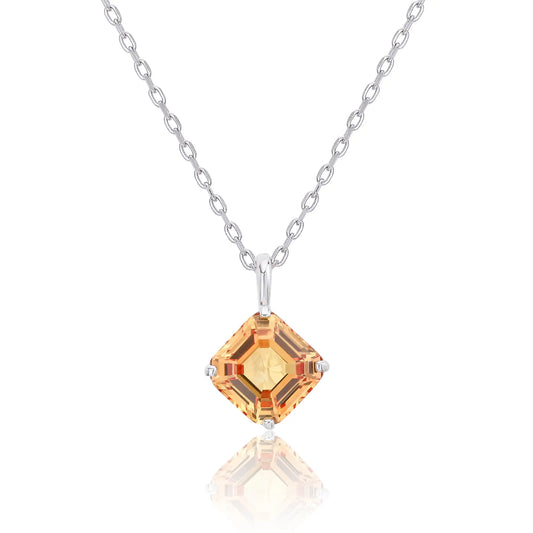 An elegant Asscher cut sapphire pendant necklace in champagne yellow, secured in a four-prong sterling silver setting with a delicate chain and reflective shadow below.